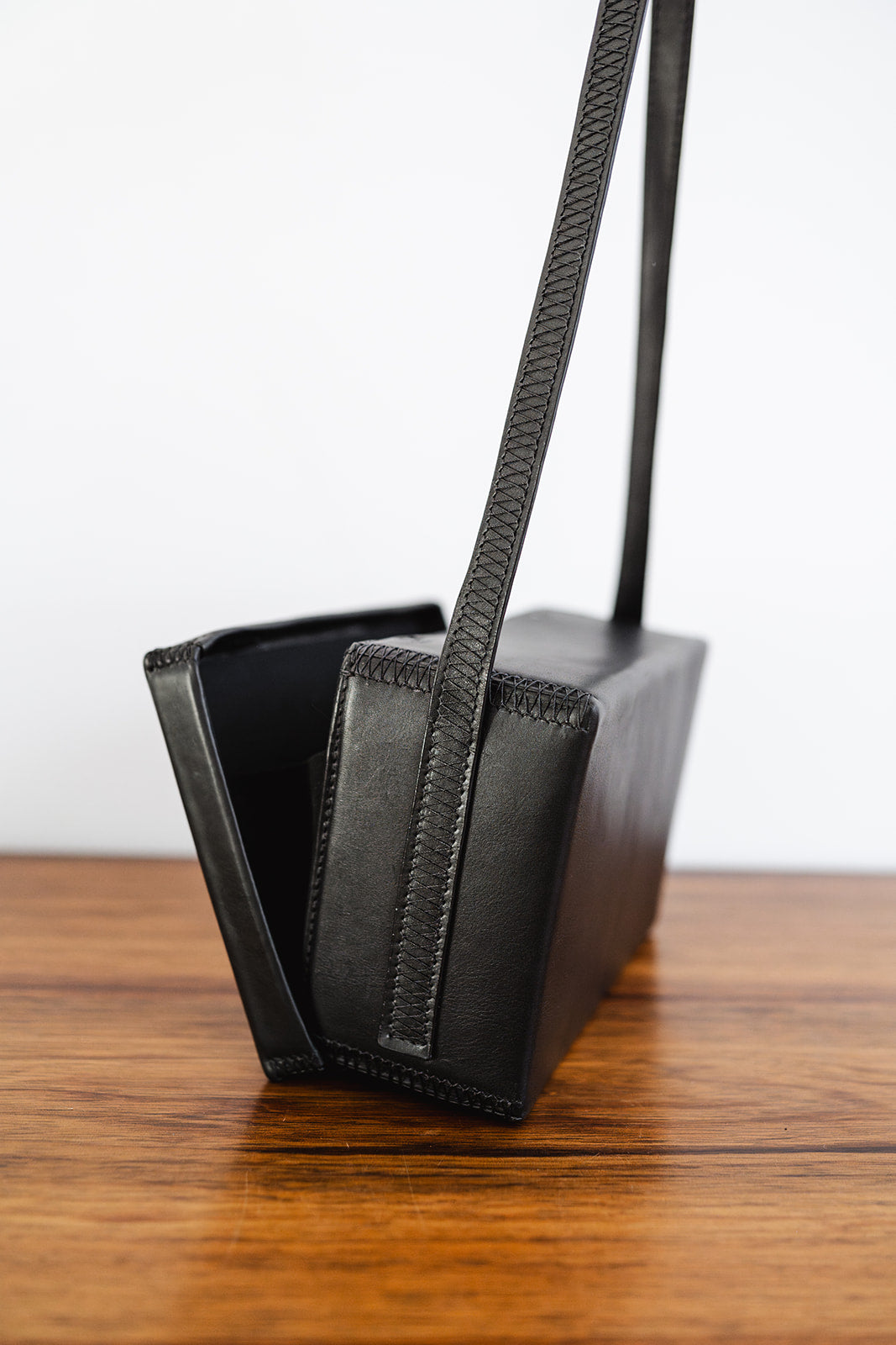 Close-up of the Ella Jackson Box Bag showing the hand-stitched strap detail and open box-style structure.