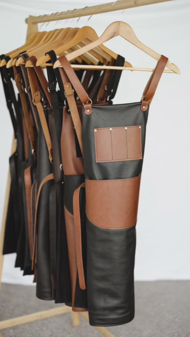 Video showing the features of the Ella Jackson Jeweller Leather Apron. This variant has a black leather body, tan straps and pockets, black lining and antique hardware. The apron has been put on a mannequin to show the front and back