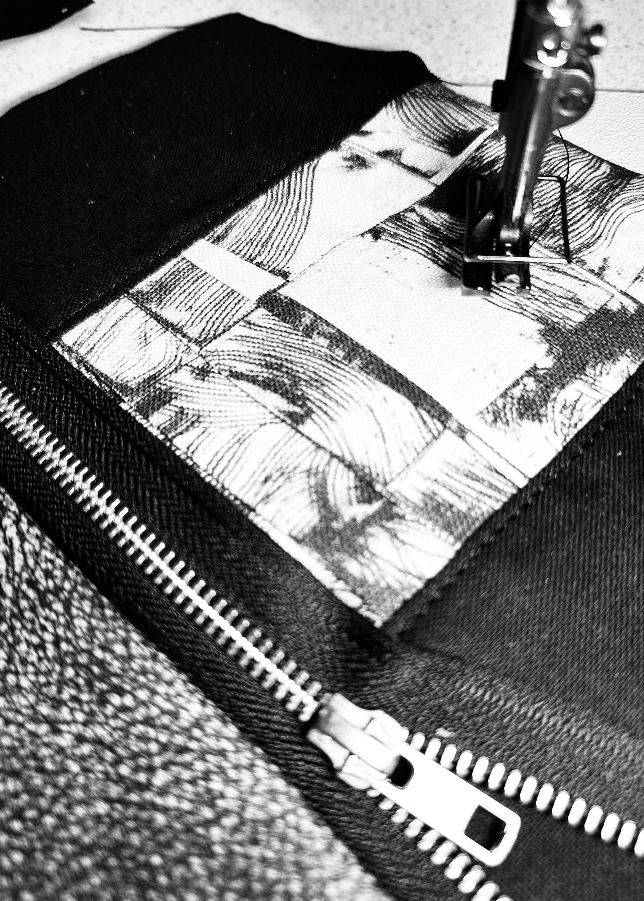 Close-up view of a leather clutch being sewn under a sewing machine foot, highlighting the zipper detail and fabric lining, with precise stitching in progress